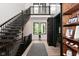 Bright open foyer featuring a staircase, wood floors, and large windows at 7070 Dean Rd, Indianapolis, IN 46220