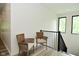 Hallway featuring modern railing, chairs, and windows offering natural light at 7070 Dean Rd, Indianapolis, IN 46220