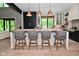 Stylish kitchen island with seating, modern pendant lights, and views to the surrounding backyard landscape at 7070 Dean Rd, Indianapolis, IN 46220