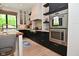 Well-equipped kitchen with sleek black cabinetry, stainless steel oven, and light gray subway tile backsplash at 7070 Dean Rd, Indianapolis, IN 46220
