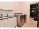 Well-equipped laundry room with modern washer and dryer, plus white cabinets for storage at 7070 Dean Rd, Indianapolis, IN 46220