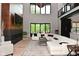 Bright living room features a fireplace, hardwood floors, soaring windows, and a large white sectional couch at 7070 Dean Rd, Indianapolis, IN 46220