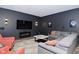 Finished basement features a living area with sectional, TV, fireplace, and accent lighting at 7070 Dean Rd, Indianapolis, IN 46220