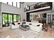 Inviting living room with a large white sectional, stylish rug, and open access to the modern kitchen at 7070 Dean Rd, Indianapolis, IN 46220
