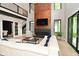 Bright living room features a fireplace, soaring windows, staircase, and comfortable sectional couch at 7070 Dean Rd, Indianapolis, IN 46220