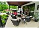 Inviting covered outdoor patio with stylish seating around a fire pit table at 7070 Dean Rd, Indianapolis, IN 46220