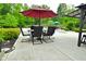 Outdoor dining area with umbrella and seating near the pool at 7070 Dean Rd, Indianapolis, IN 46220