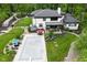 Stunning home's rear boasts a covered pool, outdoor kitchen, and lush landscaping with stone accents at 7070 Dean Rd, Indianapolis, IN 46220