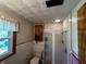 Compact bathroom with a tiled shower, toilet, vanity, and window offering natural light at 7127 Lincoln St, Anderson, IN 46013