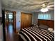 Inviting bedroom with hardwood floors, neutral walls, and natural light from window with closet at 7127 Lincoln St, Anderson, IN 46013