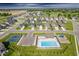Aerial view of the community with swimming pool, playground, tennis courts, and surrounding homes at 7145 Firestone Rd, Whitestown, IN 46075