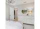 Bright bedroom featuring white dresser, round mirror, and floral bedding, creating a serene and inviting space at 7145 Firestone Rd, Whitestown, IN 46075