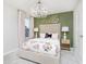Charming bedroom featuring a stylish chandelier, elegant furnishings, and a cozy floral-patterned bedspread at 7145 Firestone Rd, Whitestown, IN 46075