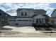 New construction two-story home featuring a spacious three-car garage and modern architectural details at 7145 Firestone Rd, Whitestown, IN 46075