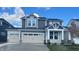 Beautiful two-story home with a three car garage and a manicured lawn at 7145 Firestone Rd, Whitestown, IN 46075