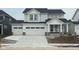 Charming two-story home boasts a three-car garage and modern farmhouse design at 7145 Firestone Rd, Whitestown, IN 46075