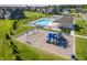 Aerial view of the community playground, pool area, and surrounding homes at 7145 Firestone Rd, Whitestown, IN 46075