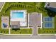 Aerial view of the community swimming pool, playground, parking lot, and tennis courts at 7145 Firestone Rd, Whitestown, IN 46075