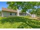 Lush backyard featuring mature trees, an enclosed porch, storage shed, and well-maintained lawn at 7215 Wet Rock Ct, Indianapolis, IN 46236