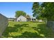 Spacious backyard with a green lawn, storage shed, and a partial view of the home's rear exterior at 7215 Wet Rock Ct, Indianapolis, IN 46236