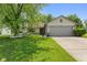 Charming single-story home featuring a well-maintained lawn, mature tree, and attached two-car garage at 7215 Wet Rock Ct, Indianapolis, IN 46236