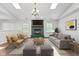 Bright living room featuring skylights, hardwood floors, fireplace, and contemporary furnishings at 7215 Wet Rock Ct, Indianapolis, IN 46236