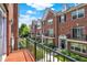 View from the balcony of a red brick townhome community with black shutters and landscaping at 73 11Th Nw St, Carmel, IN 46032