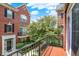 Balcony view of the brick exterior of a townhome with black shutters and a green tree at 73 11Th Nw St, Carmel, IN 46032