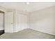 The neutral carpet and walls of this bedroom have a closet and an open doorway at 73 11Th Nw St, Carmel, IN 46032