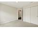 This carpeted bedroom features a closet and open doorway with neutral wall colors at 73 11Th Nw St, Carmel, IN 46032