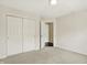 Neutral carpet and walls in this bedroom with closet doors and an open doorway at 73 11Th Nw St, Carmel, IN 46032