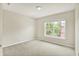 This carpeted bedroom features a window offering a view of the exterior of the building at 73 11Th Nw St, Carmel, IN 46032