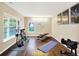 Home gym featuring hardwood floors, natural light, and fitness equipment at 73 11Th Nw St, Carmel, IN 46032