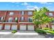 Brick townhome exterior featuring attached garages and well-maintained landscaping on a sunny day at 73 11Th Nw St, Carmel, IN 46032