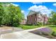 Exterior view of a brick townhome with black shutters and professional landscaping on a sunny day at 73 11Th Nw St, Carmel, IN 46032