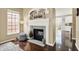 Elegant fireplace with white mantle, tile surround, and a decorative arch, complemented by hardwood floors and a window at 73 11Th Nw St, Carmel, IN 46032