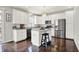 Bright kitchen featuring white cabinets, a kitchen island, stainless steel appliances, and hardwood flooring at 73 11Th Nw St, Carmel, IN 46032