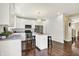 Well-lit kitchen boasting white cabinetry, hardwood floors, stainless steel appliances, and a functional kitchen island at 73 11Th Nw St, Carmel, IN 46032