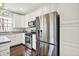Kitchen featuring stainless steel appliances, white cabinets, and hardwood floors, providing a functional cooking space at 73 11Th Nw St, Carmel, IN 46032