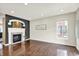 Bright living room with hardwood floors, a fireplace and a window for natural light at 73 11Th Nw St, Carmel, IN 46032