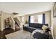 Inviting living room with a cozy sectional couch, wooden floors, staircase, and natural light from the windows at 73 11Th Nw St, Carmel, IN 46032