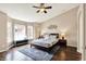 Spacious main bedroom featuring large windows, tray ceilings, ceiling fan and hardwood floors at 73 11Th Nw St, Carmel, IN 46032