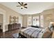 Bedroom featuring dark furniture, a bay window, and artful decorations and ceiling fan at 73 11Th Nw St, Carmel, IN 46032