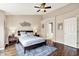 Comfortable main bedroom showcasing a ceiling fan and wood floors with decor art at 73 11Th Nw St, Carmel, IN 46032