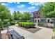 Charming brick townhomes are surrounded by lush landscaping and inviting walkways with wrought iron benches at 73 11Th Nw St, Carmel, IN 46032