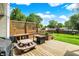 A charming backyard deck features built-in seating, a fire pit, and a picnic table, perfect for outdoor enjoyment at 7437 Lorene Ct, Indianapolis, IN 46237