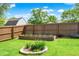 A fenced backyard with a raised garden bed and flower garden at 7437 Lorene Ct, Indianapolis, IN 46237