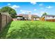 A spacious backyard featuring a well-maintained lawn, a patio, and a playset at 7437 Lorene Ct, Indianapolis, IN 46237