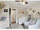 The Bedroom room features a crib, a gray rocking chair, and neutral walls decorated with animal artwork at 7437 Lorene Ct, Indianapolis, IN 46237