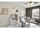 Charming Bedroom room with white crib, gray rocking chair, neutral walls, and a window overlooking the backyard at 7437 Lorene Ct, Indianapolis, IN 46237